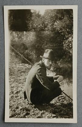 Fr. Urban Riordan fishing on a river