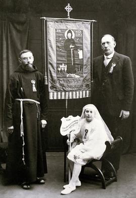 Fr. Aloysius Travers with banner commemorating the 700th anniversary of the death of Saint Francis