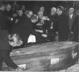 Fr.Dolan gives coffin tapes to Fr. Osmund